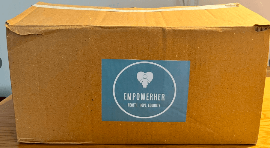 A sealed EmpowerHer FlowKit box with the branded label